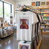 Camiseta unisex de algodón premium 200 g, inspirada en la obra: "Viajes Ancestrales #1", Autor: Weimar Alfonso Roldán